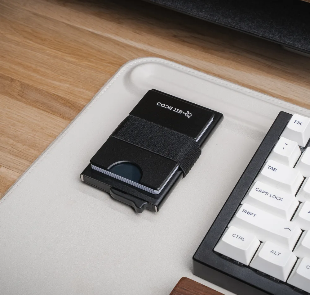 Code 118 Wallet with a cash strap and cards on a desk