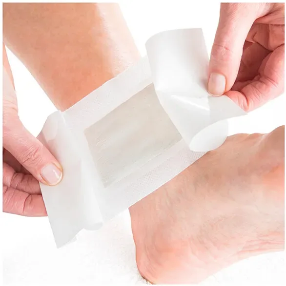 Peeling the backing off a Nuubu herbal foot pad before placing it on the sole