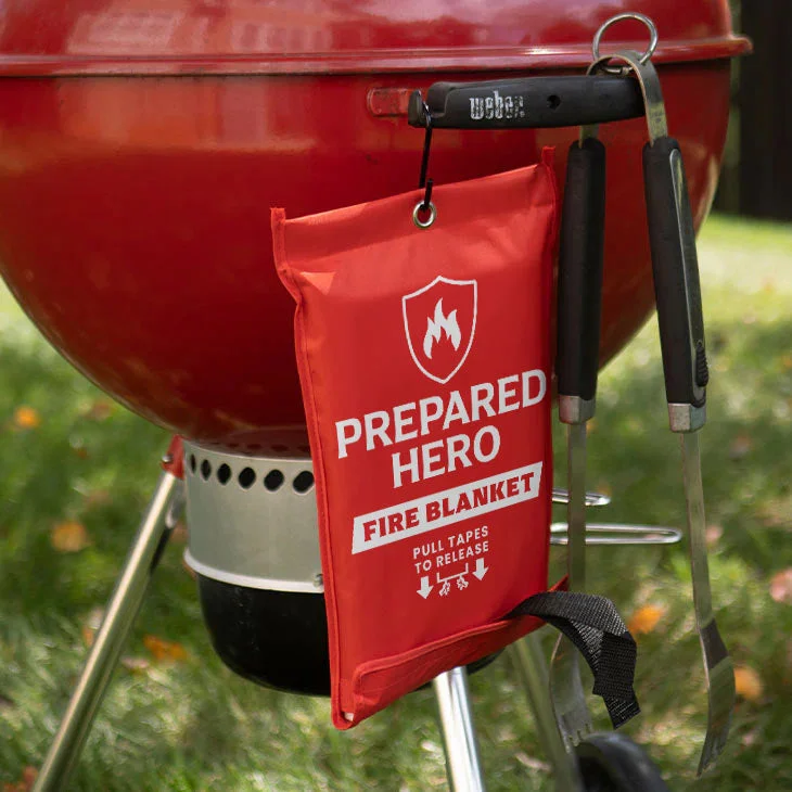 Prepared Hero fire blanket stored near an outdoor barbecue grill