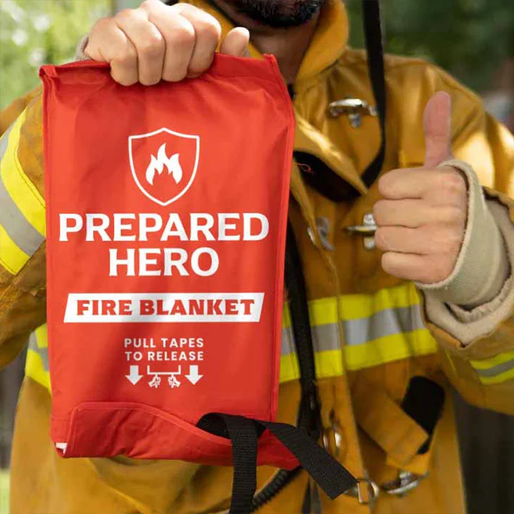 Person holding Prepared Hero fire blanket ready to deploy